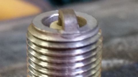 1995 Ford Bronco - A close-up view of a spark plug, a critical engine component.