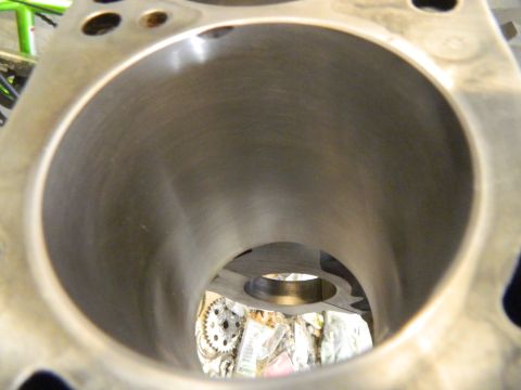 1979 Ford Bronco - Close-up view inside an engine cylinder, showing the honed surface and a glimpse of engine components in the background.