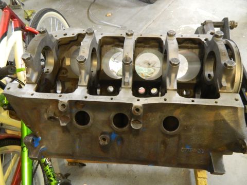 1979 Ford Bronco - Engine block with bearing caps, showing cylinder bores and oil passages. Some blue paint visible.
