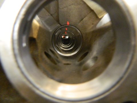 1979 Ford Bronco - Looking down into an engine cylinder, with visible red markings on the inner wall.