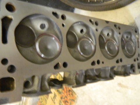 1979 Ford Bronco - Underside of an automotive cylinder head showing four machined combustion chambers and valve seats after rebuild.