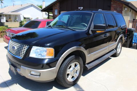 2003 Ford Expedition - Black 2003 Ford Expedition parked in a driveway with a red car beside it.