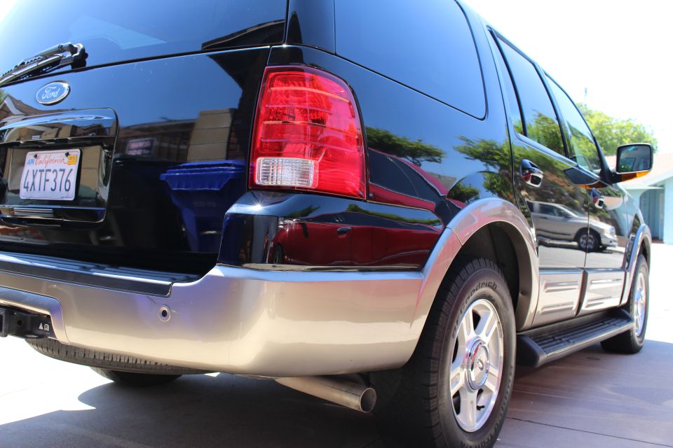 Black 2003 Ford Expedition rear quarter view, showing a license plate and chrome accents