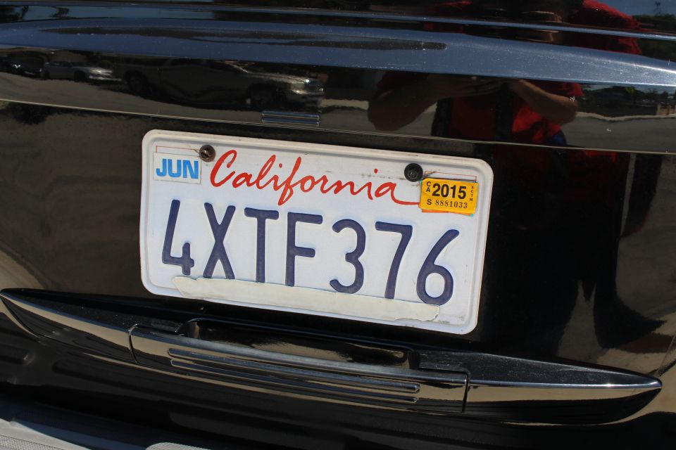 California license plate 4XTF376 with a 2015 sticker on a black vehicle