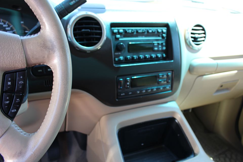Interior shot of a 2003 Ford Expedition, showing the dashboard, steering wheel, and center console