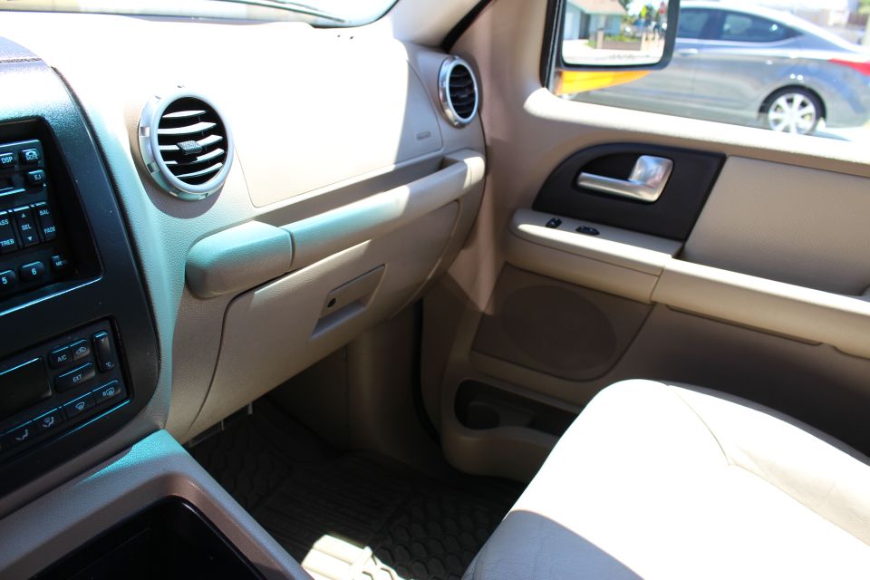 2003 Ford Expedition interior showing dashboard, air vents, door panel, and passenger seat