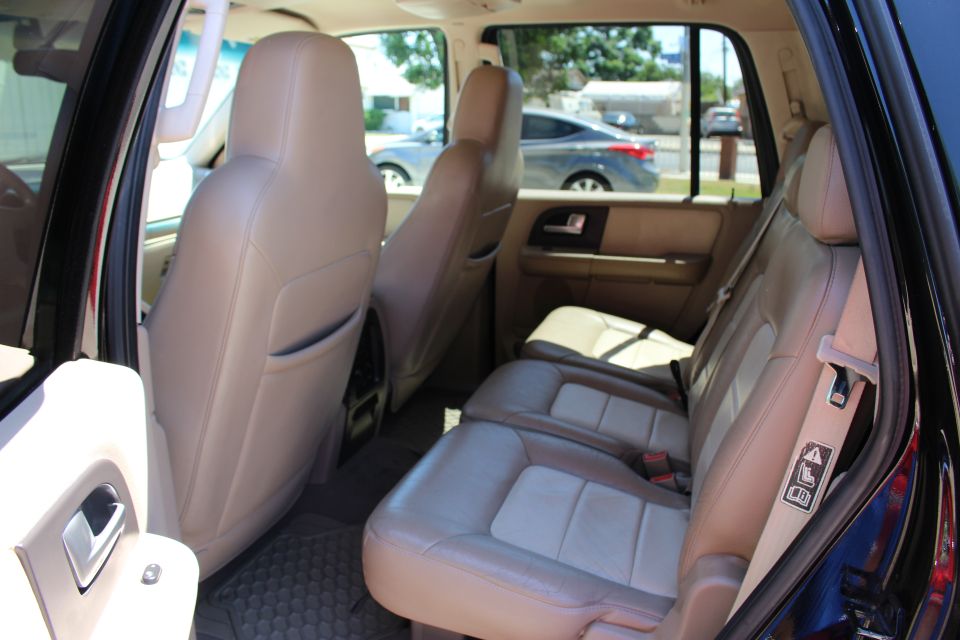 2003 Ford Expedition interior showing tan leather seats and door panel