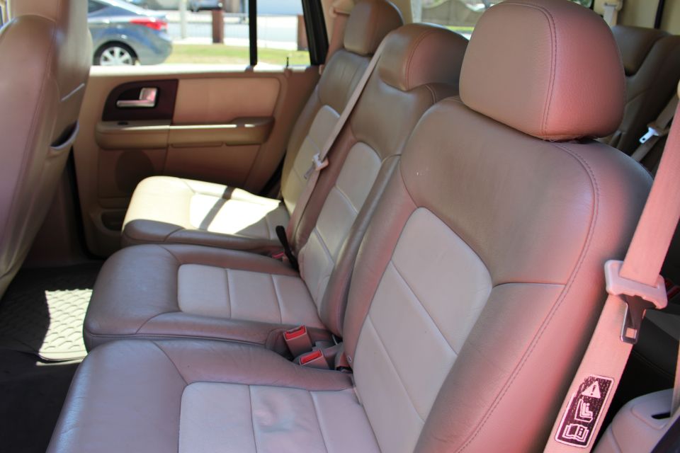 Interior view of a 2003 Ford Expedition showing tan and beige leather seats and door panel
