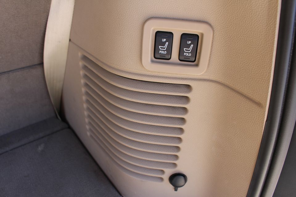 Interior trim with power seat controls labeled 'UP' and 'FOLD', and a speaker grille