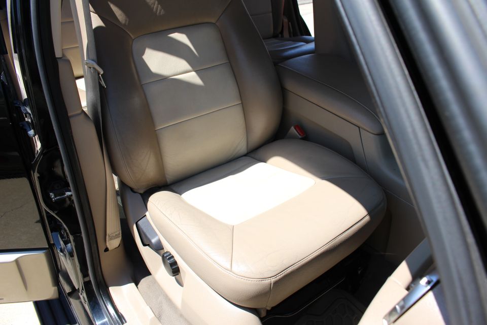 Tan leather seats and center console of a 2003 Ford Expedition
