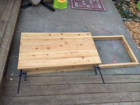 2008 Ford F-250 - A wooden table top with a circular outline is clamped to a wooden frame on a concrete surface.