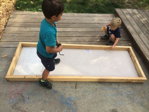 2008 Ford F-250 - Two young boys are engaged in an outdoor activity near a wooden structure on a deck.