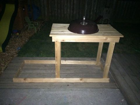 2008 Ford F-250 - An outdoor table constructed from wood planks holds a grill lid.