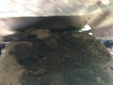 1979 Ford Bronco - The undercarriage of a vehicle is shown, covered in dirt and grime, with a website logo in the corner.