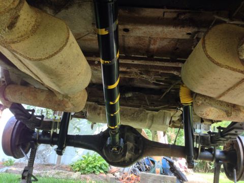 1979 Ford Bronco - The underside of a 1979 Ford Bronco reveals its rear axle, suspension components, and exhaust system.