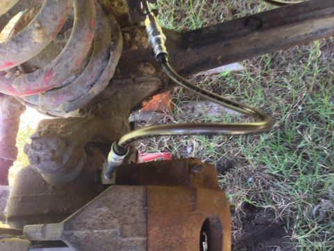 1979 Ford Bronco - Brake caliper and hose assembly, likely from a truck or SUV, showing wear and tear.