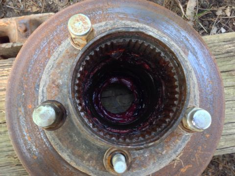 1979 Ford Bronco - Close-up view of a greased wheel hub, showing the internal splines and lug bolt mounts.