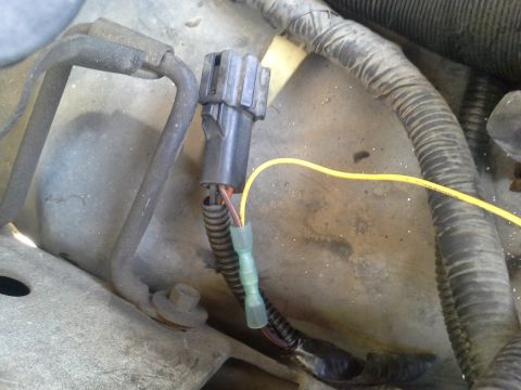 1991 Ford F-250 - Close-up of an engine wiring harness connector with a yellow wire and a blue crimp connector attached. The registry claims this is a 1991 F…