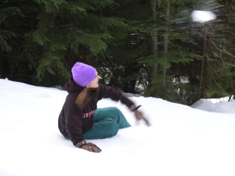 1991 Ford Bronco - A person enjoys a snowy day by throwing a snowball in a wooded area.