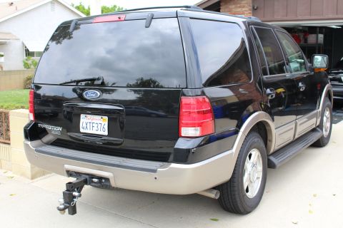2003 Ford Expedition - Rear view of a black 2003 Ford Expedition, equipped with a trailer hitch and a California license plate.