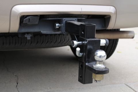 2003 Ford Expedition - Trailer hitch assembly mounted to the rear of a vehicle, spare tire is visible below.