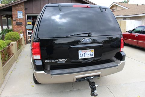2003 Ford Expedition - The rear of a black Ford Expedition is shown parked in a driveway.