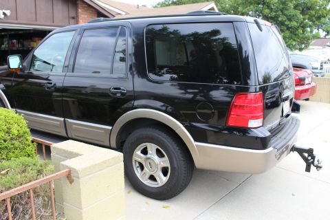 2003 Ford Expedition - Rear view of a black 2003 Ford Expedition with tan lower body trim.