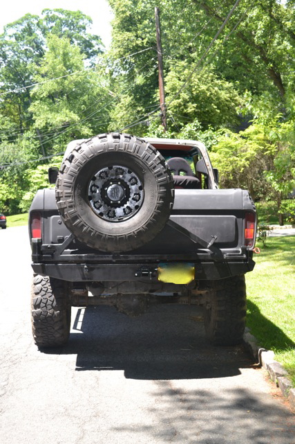 1979 Ford Bronco - Rear view of a black 1978 Ford Bronco with a spare tire and aftermarket bumper.