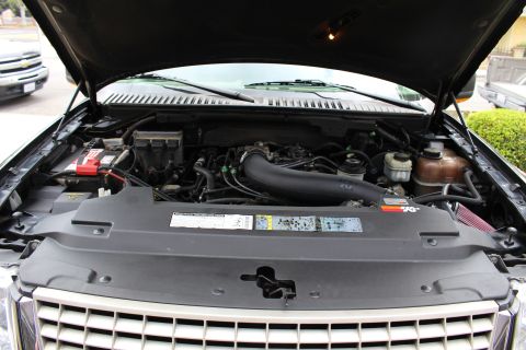 2003 Ford Expedition - The engine bay of a black 2003 Ford Expedition, showing the engine and various components under the hood.