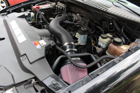 2003 Ford Expedition - Close-up of a vehicle's engine bay, highlighting a K&N air intake system with a pink filter.
