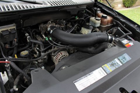 2003 Ford Expedition - The engine bay of a vehicle, a K&N air intake system and various engine components.