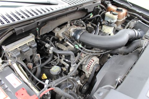 2003 Ford Expedition - The engine bay of a Ford Expedition, showing the V8 engine and various components.