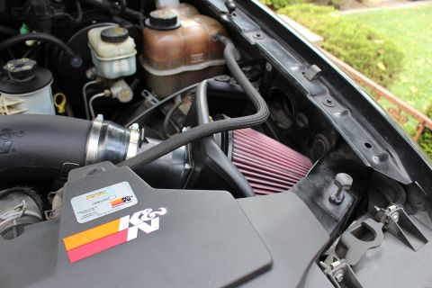 2003 Ford Expedition - Close-up view of an engine bay, highlighting an aftermarket K&N air intake system installed on the vehicle.