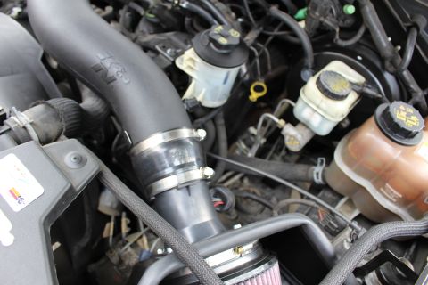 2003 Ford Expedition - Close-up of an engine bay a K&N air intake system and brake fluid reservoir.