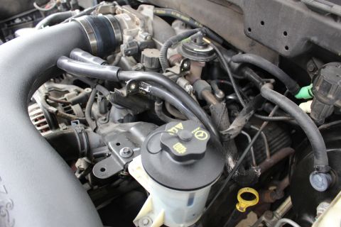 2003 Ford Expedition - Close-up view of a vehicle's engine bay, showing complex mechanical components and fluid lines.