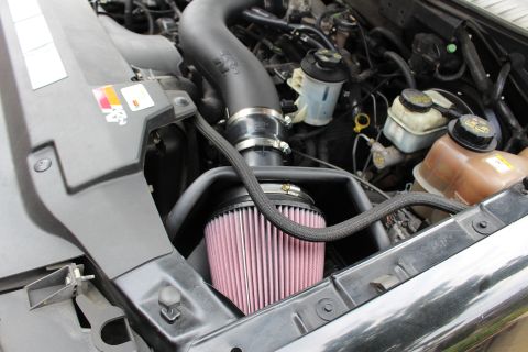 2003 Ford Expedition - Close-up view of an engine bay, highlighting an aftermarket K&N air intake system.