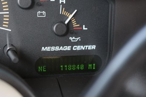 2003 Ford Expedition - Close-up of a vehicle's dashboard gauges, showing mileage and warning lights.