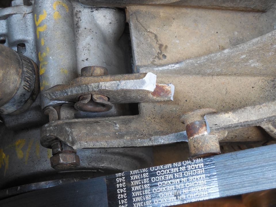 While swapping back to my good alternator, the bracket broke.  From the color of the fracture surface, I can see that it has been cracked for a long time.