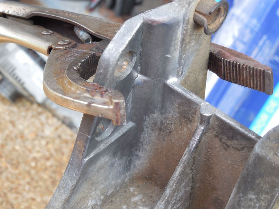 Rather than drive the CV to the JY to look for another bracket, I'll try to weld this one back together, mainly for the practice.  If it breaks again, I'll replace it, but I need to learn.  I cleaned the fracture & vicinity with stainless wire brushes that have never been used on steel, then used a small BP hammer to re-set the pieces together so the seam is minimized.  The vise grips are just there for the initial tacks.