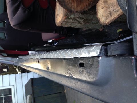 1979 Ford Bronco - Interior view of a vehicle's cargo area, loaded with firewood.