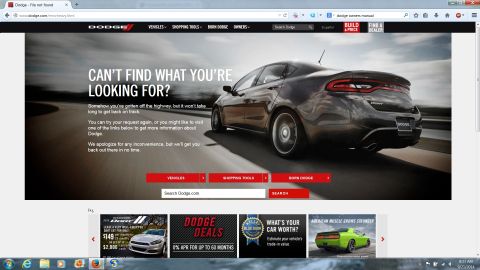 2015 Dodge Challenger - A dark gray Dodge Dart sedan is shown from the rear three-quarter angle on a highway.