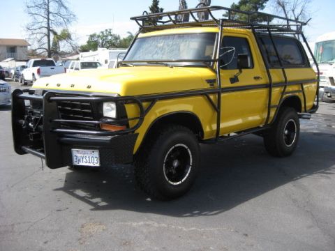 1979 Ford Bronco - This yellow Ford Bronco, likely a 1978 model, is equipped with a heavy-duty brush guard and a roof rack.