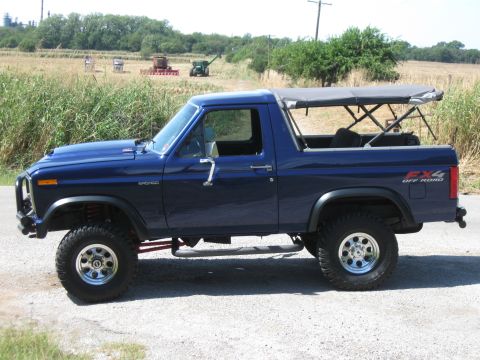 1982 Ford Bronco - This blue 1982 Ford Bronco features a removable soft top and an FX4 Off Road decal on the rear fender.