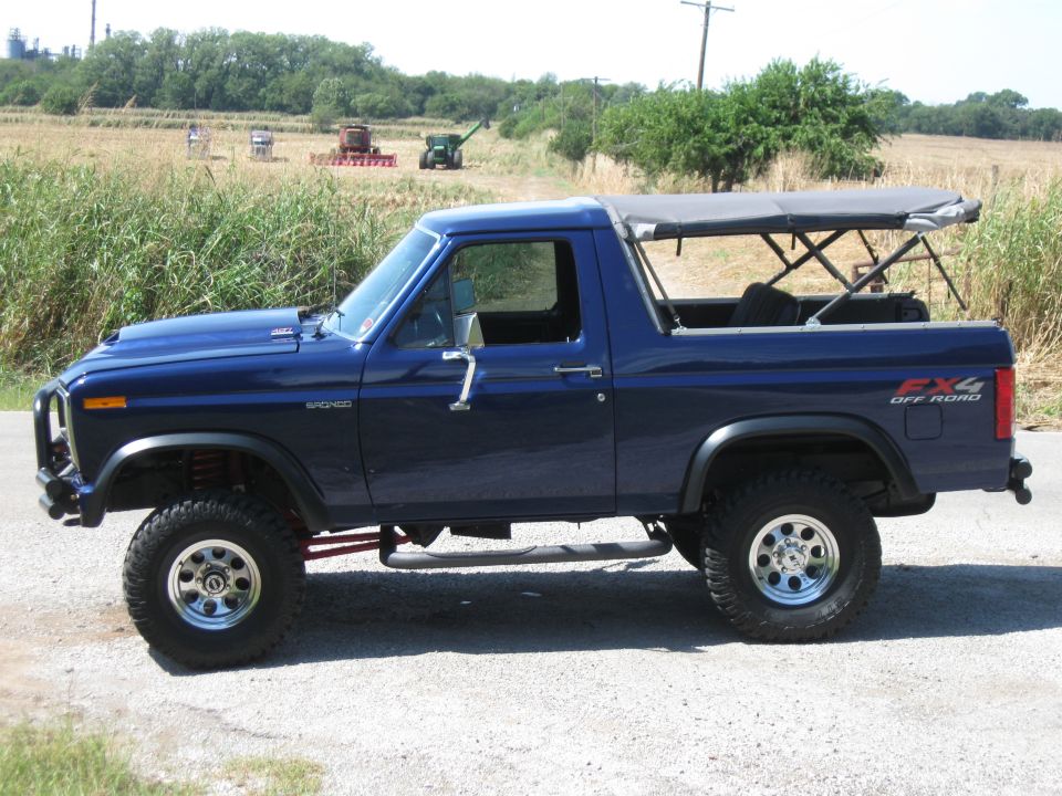Blue 1982 Ford Bronco side view with soft top and FX4 Off Road decal