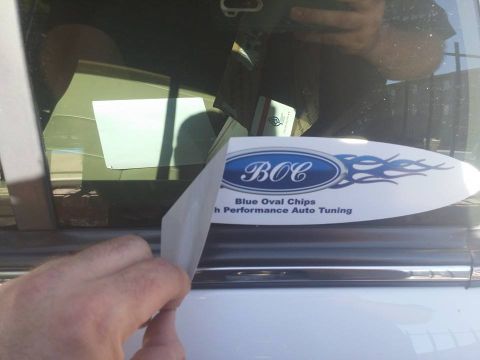 2000 Mercury Grand Marquis - A sticker is being removed from a vehicle's window, revealing the interior.