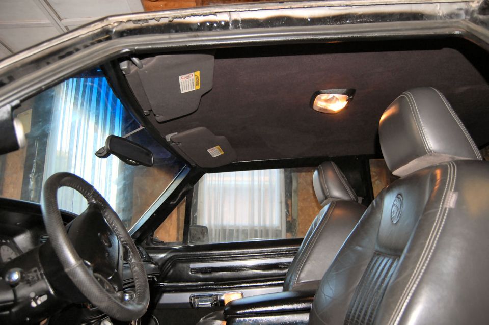 1985 Mercury Grand Marquis interior showing leather seats, steering wheel, and sun visors