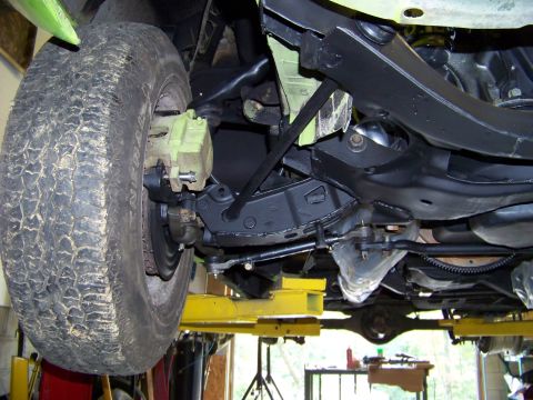 1974 Dodge Challenger - Underside view of a vehicle's front suspension components, including the tire and brake assembly.