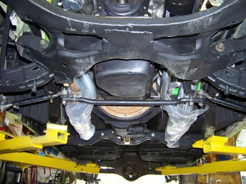1974 Dodge Challenger - Front suspension and undercarriage of a 1974 Dodge Challenger, showing steering components and exhaust.