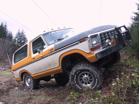 1991 Ford Bronco - Ford Bronco navigating rough terrain with its front wheels angled.