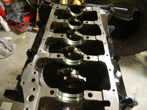 1979 Ford Bronco - Close-up view of an engine block's crankshaft bearing saddles and connecting rod caps.
